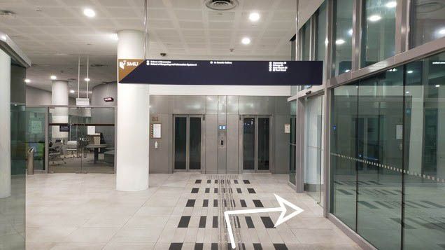 Turn right before the lifts and take the escalator up