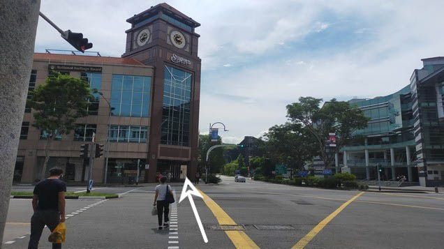 Cross the traffic light. LKCSB is diagonally from where you are.