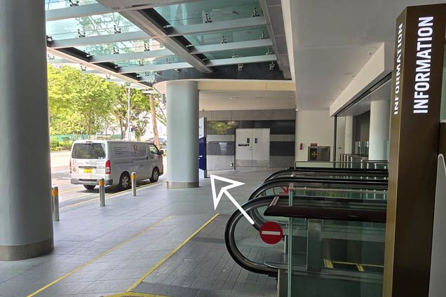 At street level, walk towards the building signage