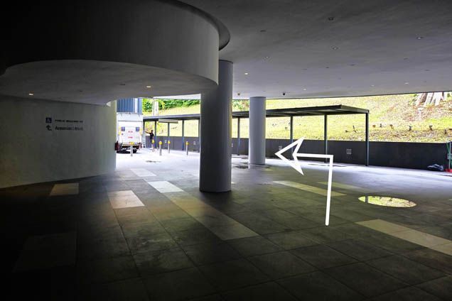 Walk past the pillars and walk along the sheltered walkway